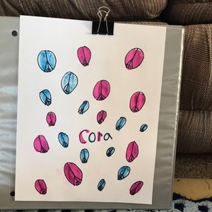 It is blue and pink has peace sines name on it is Cora.